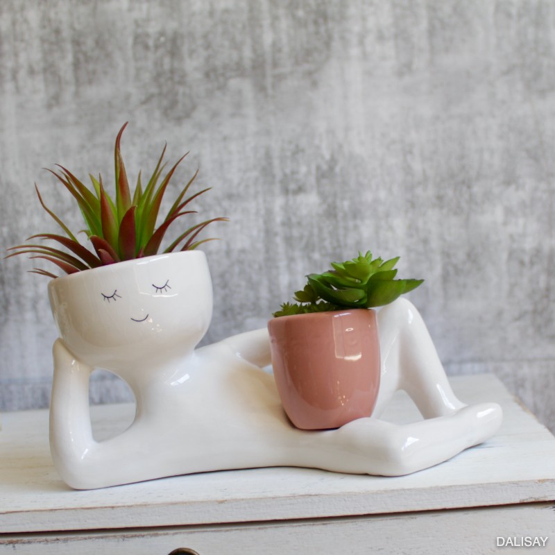Nude Relaxing Person Holding a Pot Planter