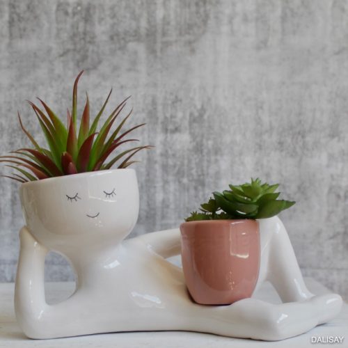 Nude Relaxing Person Holding a Pot Planter