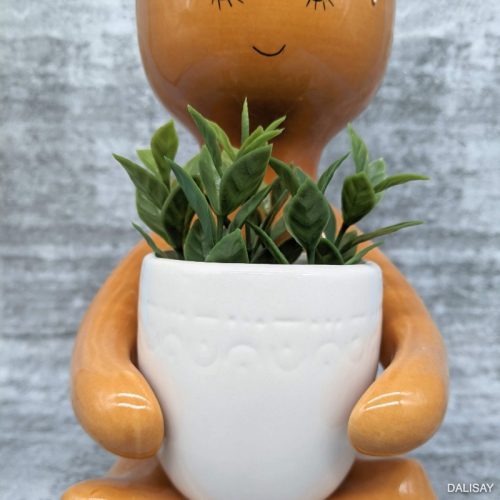 Caramel Sitting Person Holding A Pot Planter