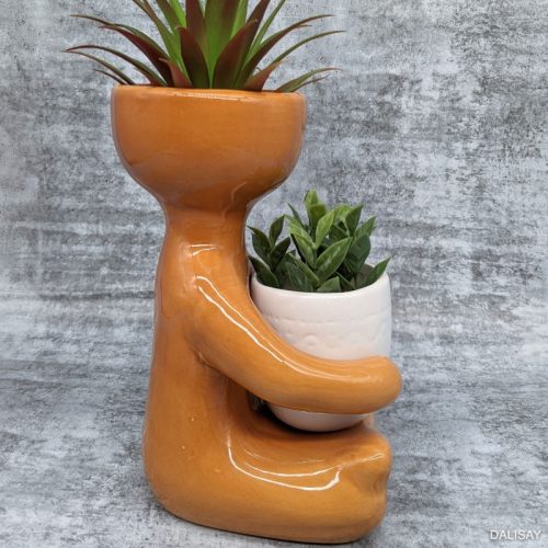 Caramel Sitting Person Holding A Pot Planter