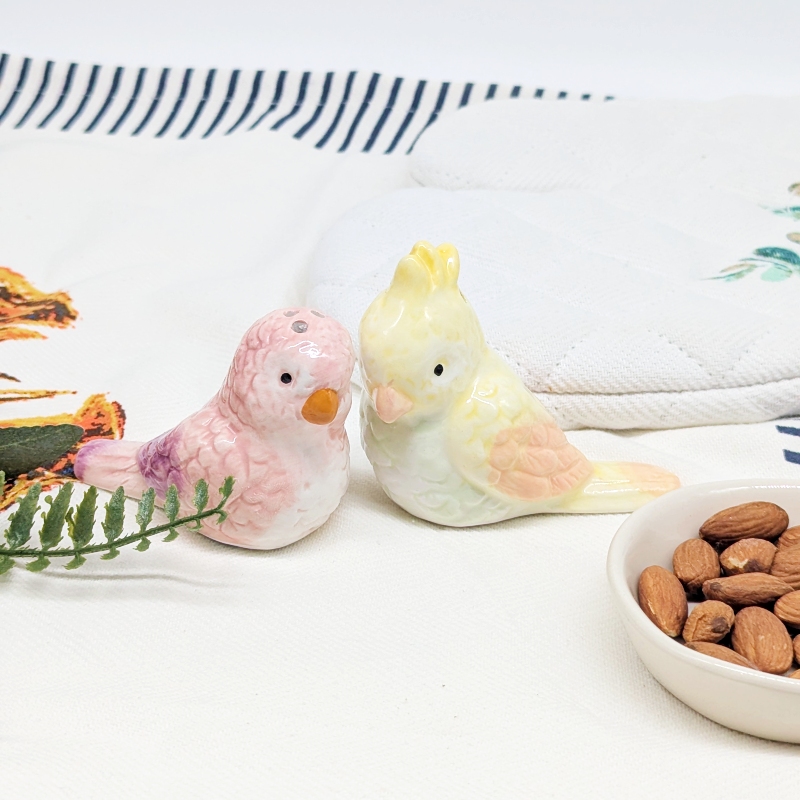 PXL_20251105_032030887 Purple Yellow Parrot Salt Pepper Shaker Set